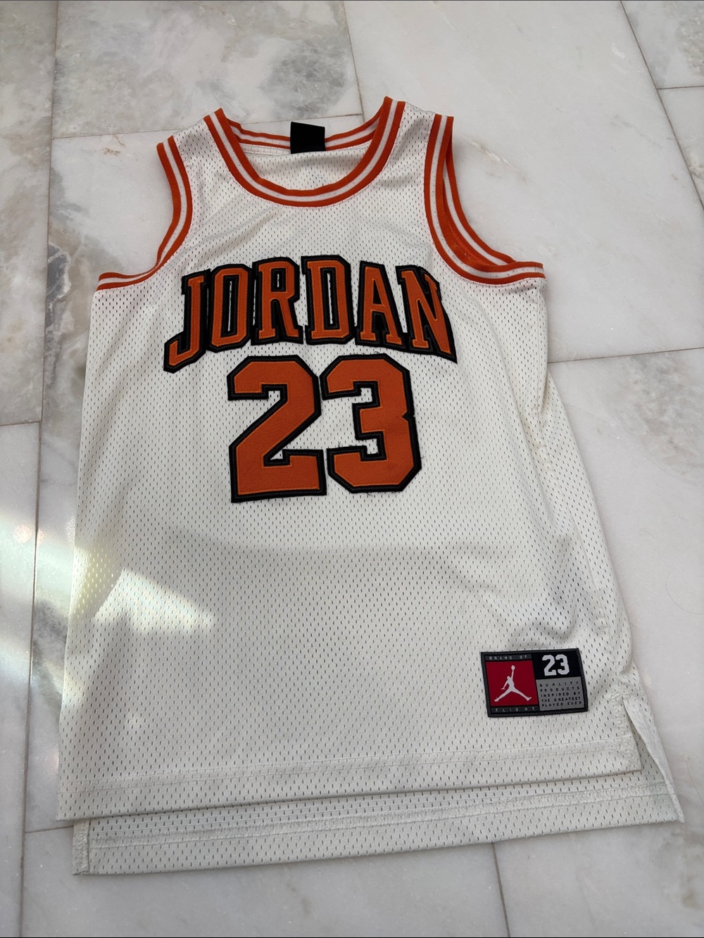 Cream / orange Jordan basketball jersey
